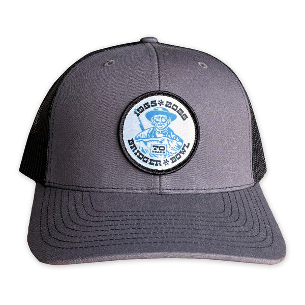 Gray trucker cap with a blue and white patch on a white background